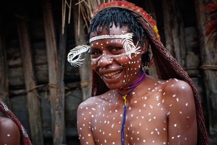 PAPUA PROVINCE, INDONESIA -DECEMBER 28: The woman of a Papuan tribe in traditional clothes and coloring at New Guinea Island, Indonesia on December 28, 2010